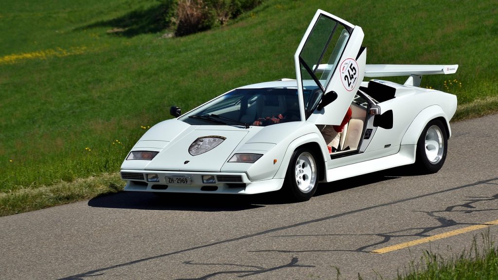 This iconic white Lamborghini Countach, cruising with its scissor door raised, perfectly illustrates why savvy owners seek Montana luxury tax savings for an exotic car purchase.