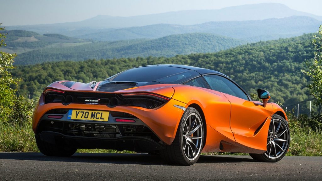 This image shows a bright orange McLaren supercar against a mountain backdrop, and with Ride Legal you can register your vehicle seamlessly and get plates delivered to your door.