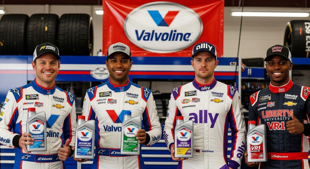 Four NASCAR drivers standing in a line in a garage, holding bottles of Valvoline motor oil.